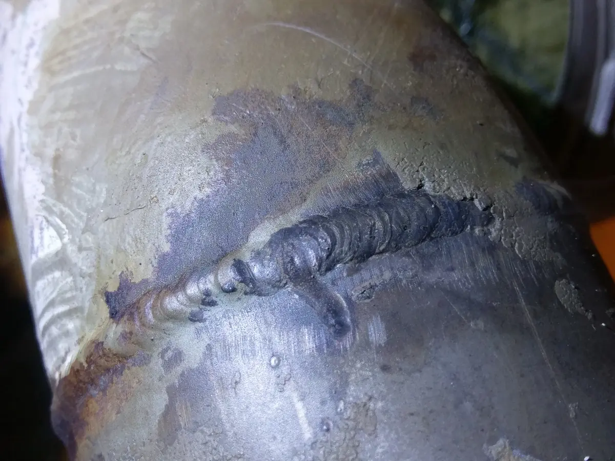 Close view of the reported leak area at the exposed process-line weld.