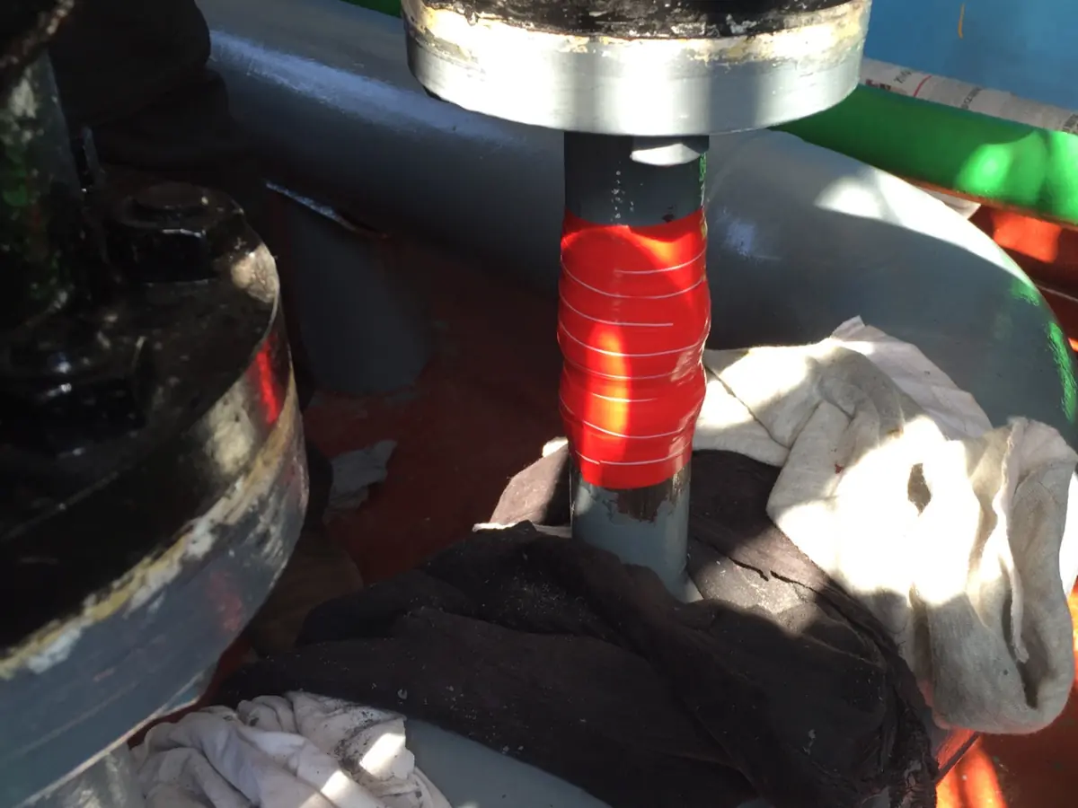 Red site-formed ISB under construction around a DN100 oilfield steel pipe