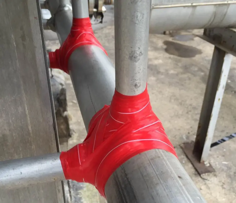 Red site-formed ISBs around two welded branch connections before external protection